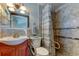 Bathroom featuring a walk-in shower, wood vanity, and accessibility grab bars at 3805 Baden Dr, Holiday, FL 34691