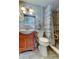 Bathroom featuring a walk-in shower, wood vanity, and accessibility grab bars at 3805 Baden Dr, Holiday, FL 34691