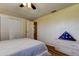 Bedroom featuring hardwood floors, a ceiling fan, a closet, and an ensuite bathroom at 3805 Baden Dr, Holiday, FL 34691