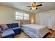Bedroom featuring hardwood floors, a ceiling fan, a blue couch, and closet at 3805 Baden Dr, Holiday, FL 34691