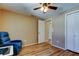 A bright bedroom with hardwood floors, a ceiling fan, and neutral walls at 3805 Baden Dr, Holiday, FL 34691