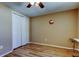 A hardwood floor bedroom with a ceiling fan, closet, and neutral walls at 3805 Baden Dr, Holiday, FL 34691