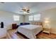 Bedroom featuring hardwood floors, a ceiling fan, and a blue couch at 3805 Baden Dr, Holiday, FL 34691