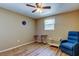 A simple, but brightly lit bedroom featuring hard wood flooring and an armchair at 3805 Baden Dr, Holiday, FL 34691