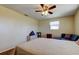 Bedroom featuring hardwood floors, a ceiling fan, and a blue couch at 3805 Baden Dr, Holiday, FL 34691