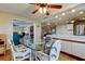 Open-concept dining area with wicker chairs, glass table, and seamless transition into the kitchen at 3805 Baden Dr, Holiday, FL 34691