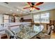 Well-lit dining space with a glass table, seamlessly connected to a modern kitchen with stainless steel appliances at 3805 Baden Dr, Holiday, FL 34691