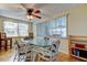 Comfortable dining room with a glass table, wicker chairs, and views through the window at 3805 Baden Dr, Holiday, FL 34691