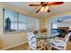 Bright dining room featuring a glass table, stylish wicker chairs, and a ceiling fan for added comfort at 3805 Baden Dr, Holiday, FL 34691