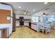 Bright eat-in kitchen featuring stainless steel appliances, tile backsplash, white cabinetry, and tile floors at 3805 Baden Dr, Holiday, FL 34691