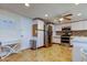 Well-lit kitchen with stainless steel appliances, white cabinets, tile floors, and a stainless steel trash can at 3805 Baden Dr, Holiday, FL 34691