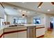Open kitchen with modern appliances, white countertops, and views of the living area at 3805 Baden Dr, Holiday, FL 34691