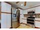Close-up of kitchen showcasing stainless steel appliances, including a refrigerator, oven, and microwave at 3805 Baden Dr, Holiday, FL 34691