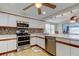 Updated kitchen with stainless steel appliances, tile backsplash, and white cabinets at 3805 Baden Dr, Holiday, FL 34691