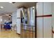 Stainless steel refrigerator in the kitchen, with views of the living area in the background at 3805 Baden Dr, Holiday, FL 34691