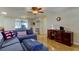 Comfortable living area with natural light, tile flooring, and a furniture set in the corner at 3805 Baden Dr, Holiday, FL 34691