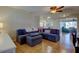 Cozy living room features tile flooring, a ceiling fan, and a comfortable sectional sofa at 3805 Baden Dr, Holiday, FL 34691