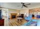 Comfortable living area featuring a fireplace, ceiling fan, and an open layout for easy entertaining at 3805 Baden Dr, Holiday, FL 34691