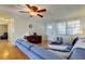 Well-lit living room with tile flooring, white walls, and inviting sectional sofa at 3805 Baden Dr, Holiday, FL 34691