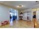 Open living space featuring tile floors, neutral walls, and bright views into other rooms at 3805 Baden Dr, Holiday, FL 34691