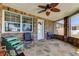 Relaxing outdoor space with flagstone flooring, ceiling fan, and brick walls with natural light at 3805 Baden Dr, Holiday, FL 34691