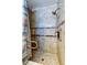 Shower featuring stone-look tile, a shower bench, and accessibility grab bars at 3805 Baden Dr, Holiday, FL 34691