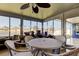 Bright sun room featuring tile floors, a ceiling fan, and views of the water at 3805 Baden Dr, Holiday, FL 34691