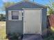 Exterior shot of a shed in the backyard, equipped with a sliding door and window at 4066 37Th N Ave, St Petersburg, FL 33713