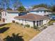 Expansive home featuring a well-manicured lawn, neutral palette and arched windows at 4809 W Juno St, Tampa, FL 33629