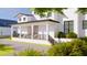 Charming two-story white home with a covered front porch and well-maintained landscaping at 4809 W Juno St, Tampa, FL 33629