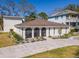 Bright home with paved driveway, well-manicured lawn and arched windows at 4809 W Juno St, Tampa, FL 33629