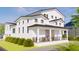 Beautiful two-story home featuring a welcoming front porch and pristine white siding at 4809 W Juno St, Tampa, FL 33629