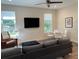 Well-lit living room with comfortable seating, large windows, modern decor, and stylish fixtures at 4809 W Juno St, Tampa, FL 33629