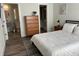 Inviting bedroom with modern finishes, wood-look flooring, ensuite bathroom, and a walk-in closet at 4809 W Juno St, Tampa, FL 33629