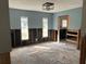 This unfinished room with blue walls shows studs and a raw concrete floor at 4809 W Juno St, Tampa, FL 33629