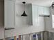 Light blue cabinets and white subway tile with black light fixtures are being installed at 4809 W Juno St, Tampa, FL 33629