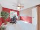 A functional office space features neutral and red walls, tile flooring, and a window, providing a dedicated and efficient workspace at 507 7Th Ne Ave, Largo, FL 33770