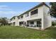 Exterior view of townhomes with patios and backyards featuring lawn and seating at 538 Walden Ct, Dunedin, FL 34698