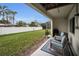 Serene backyard patio with seating, overlooking the green lawn and privacy fence at 538 Walden Ct, Dunedin, FL 34698