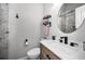Bright bathroom featuring modern fixtures, a wood vanity, toilet and shower with glass doors at 538 Walden Ct, Dunedin, FL 34698