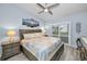 Bedroom with light blue walls, a queen-sized bed, and a sliding glass door to the outside at 538 Walden Ct, Dunedin, FL 34698