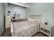 Comfortable bedroom featuring a large shuttered window and coastal decor at 538 Walden Ct, Dunedin, FL 34698