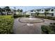 Community space with decorative fountain surrounded by lush landscaping and residential buildings at 538 Walden Ct, Dunedin, FL 34698