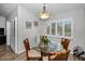 Dining area with a round table, chairs, shuttered windows, and modern decorative wall art at 538 Walden Ct, Dunedin, FL 34698