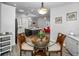 Open-concept dining area flows into the kitchen and living room with round table and 4 chairs at 538 Walden Ct, Dunedin, FL 34698