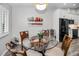 Dining area with a round table, chairs, shuttered windows, with kitchen in the background at 538 Walden Ct, Dunedin, FL 34698