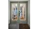 Elegant entryway features glass doors and views into the interior at 538 Walden Ct, Dunedin, FL 34698