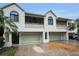 Charming townhouse with a two-car garage and tropical landscaping at 538 Walden Ct, Dunedin, FL 34698