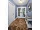 Stylish foyer with tile flooring, white console table, and blue accent walls at 538 Walden Ct, Dunedin, FL 34698