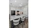 Modern kitchen with white cabinetry, granite countertops, and stainless steel appliances at 538 Walden Ct, Dunedin, FL 34698